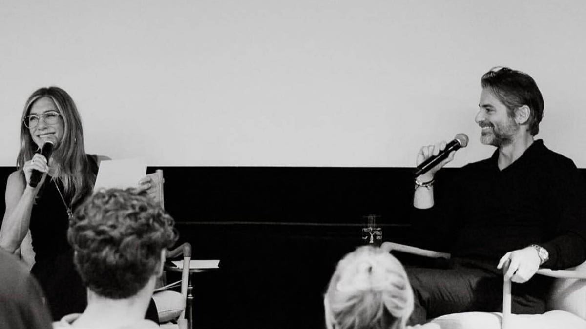 Jennifer Aniston on stage with her boyfriend Jim Curtis