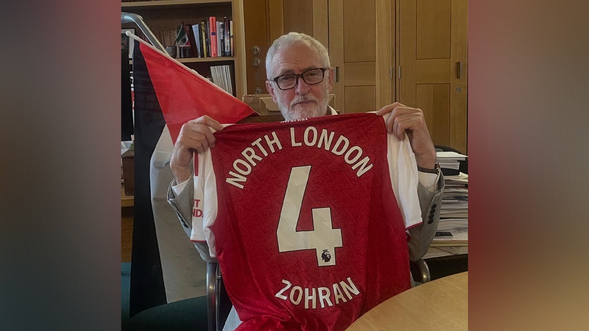 Jeremy Corbyn holding up a jersey.