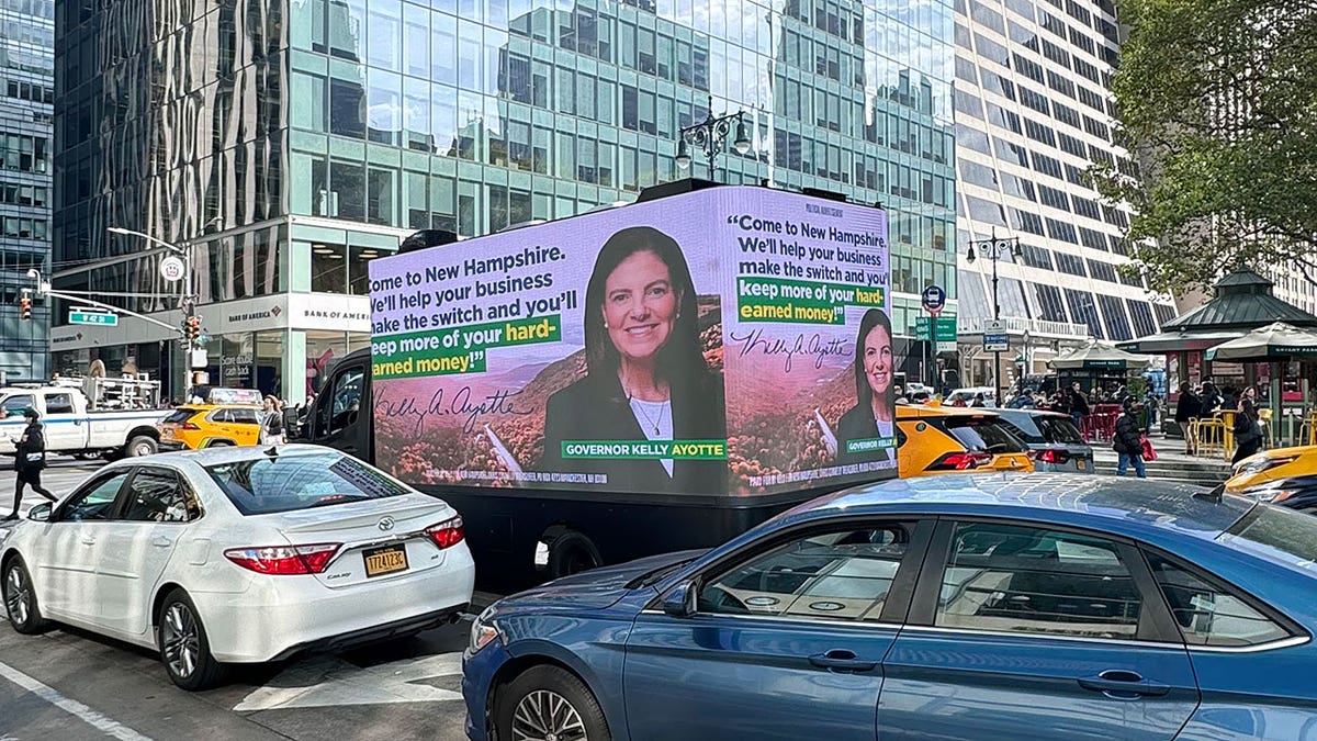 A van in midtown Manhattan telling New Yorkers to move to New Hampshire.