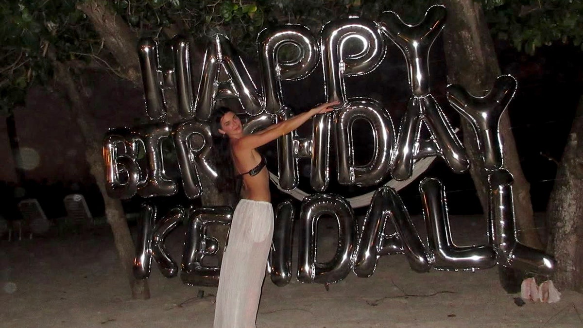 Kendall Jenner wears her bikini with pants while posing besides her birthday balloons