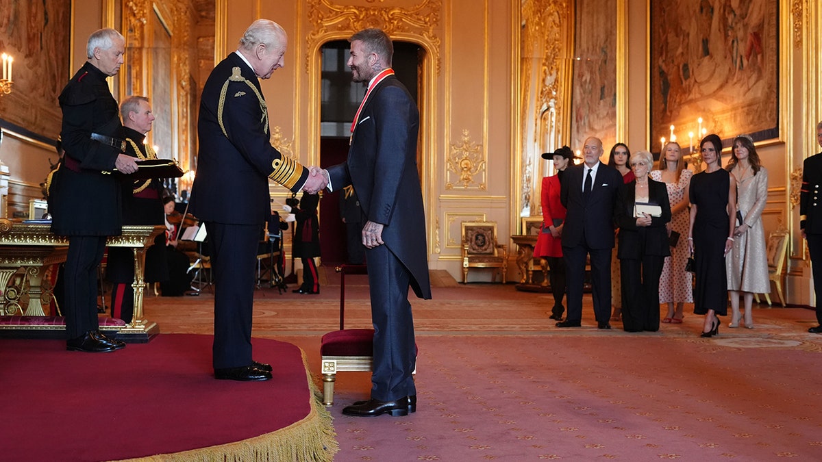 King Charles III knights Sir David Beckham during an Investiture ceremony at Windsor Castle in Berkshire, England.