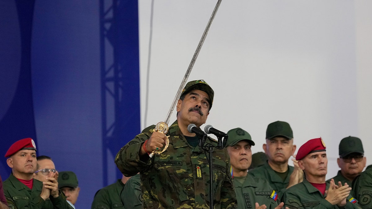 Maduro brandishes sword at rally as he rails against 'imperialist aggression' amid rising tensions with US at george magazine
