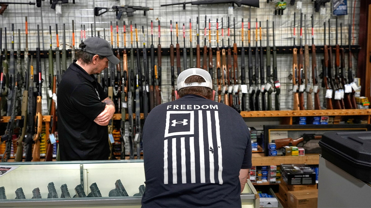 A shopper browses inside a gun store.