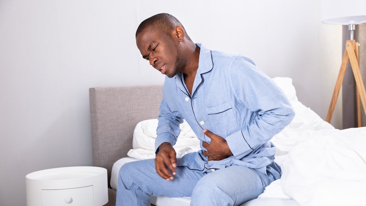 Man with acid reflux in bed