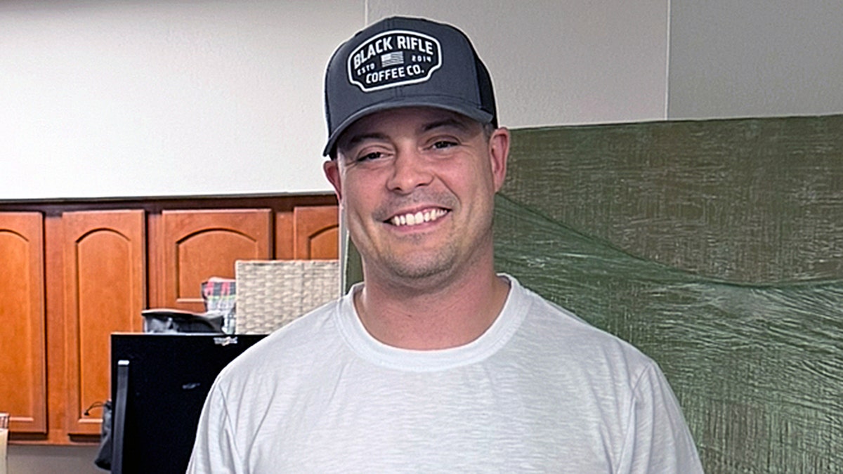 Von Letkemann at home wearing a Black Rifle Coffee Co. hat.
