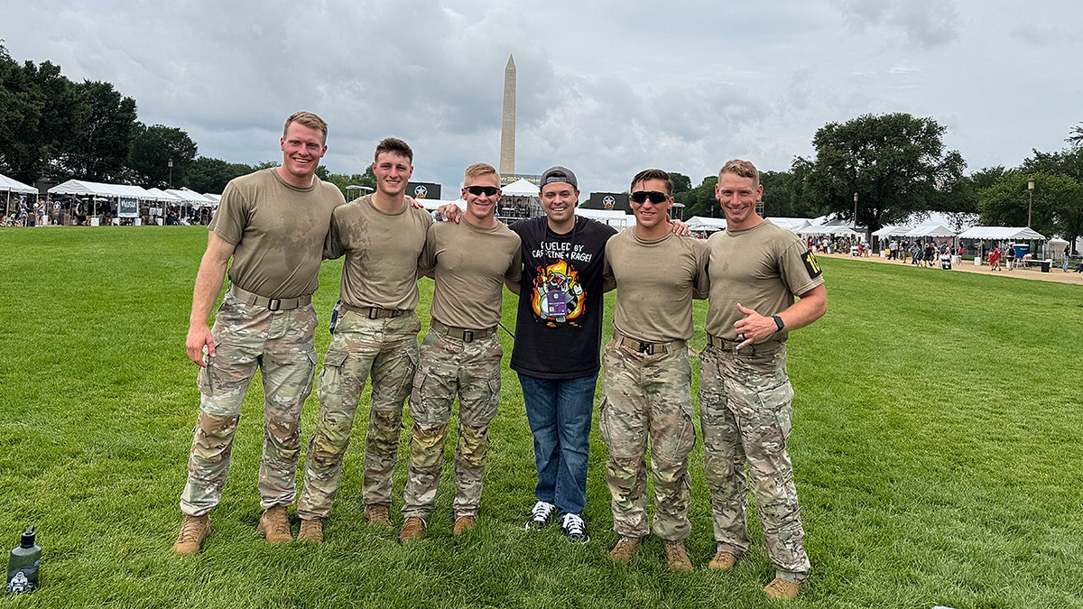 Von Letkemann stands with service members near the Washington Monument.