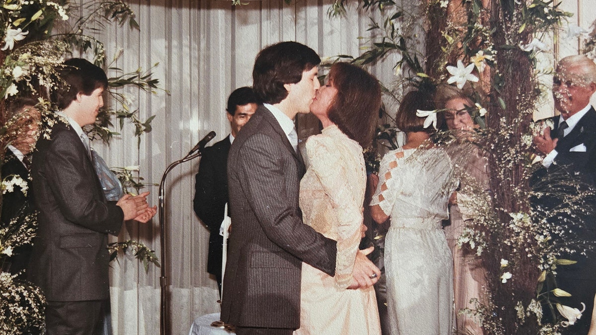 Mary Tyler Moore kissing Dr. S Robert Levine on her wedding day.