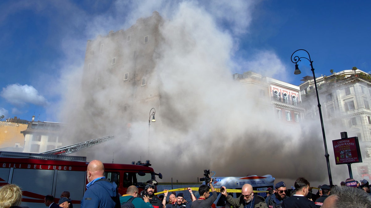 Worker dies after 11-hour rescue from collapsed medieval tower in Rome 1 medieval tower Torre dei Conti building collapse with clouds of debris and on lookers