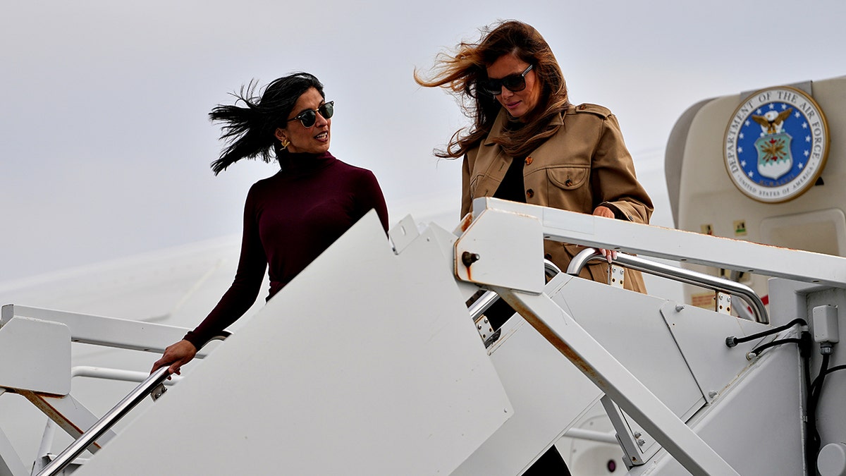 First lady Melania Trump, right, and second lady Usha Vance walking down stairs