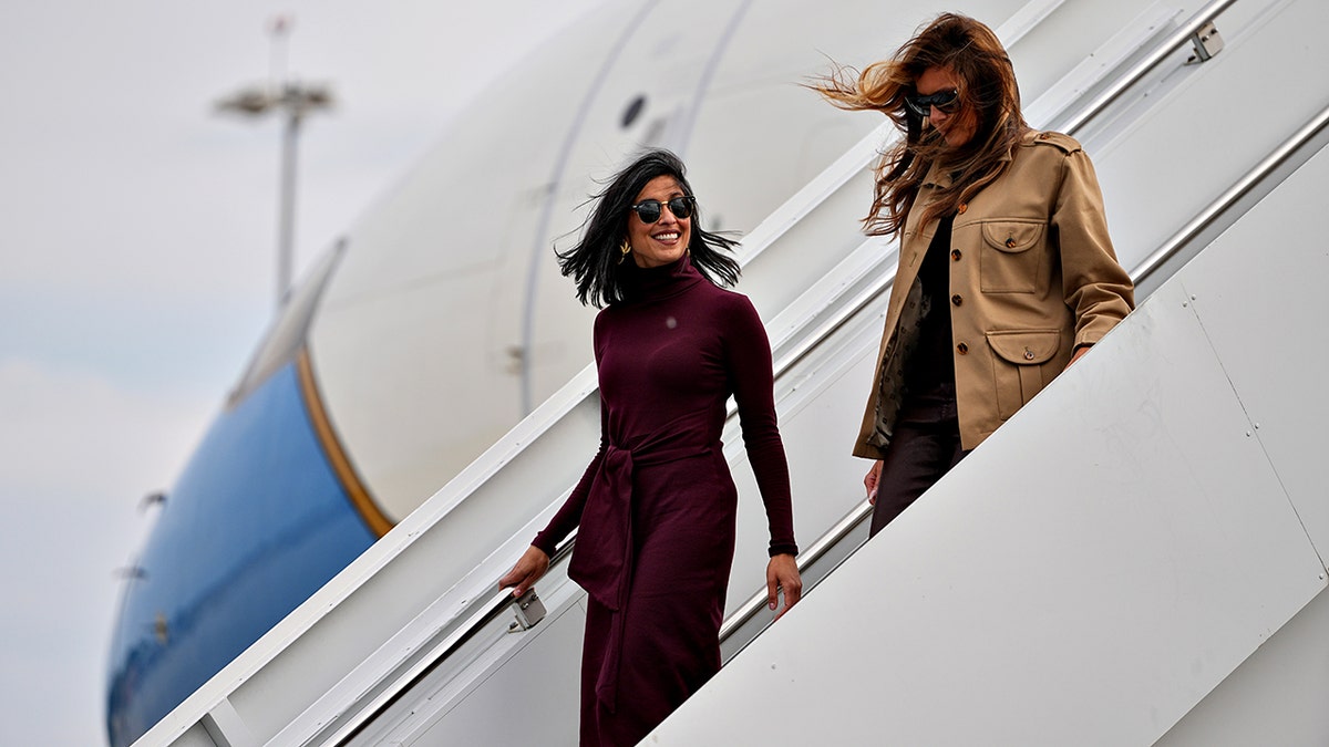 First lady Melania Trump, right, and second lady Usha Vance walking down stairs