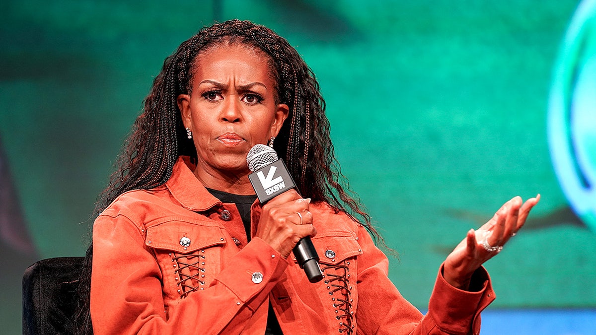 Michelle Obama speaks on stage during a live recording of her podcast with Craig Robinson at the SXSW Festival in Austin.