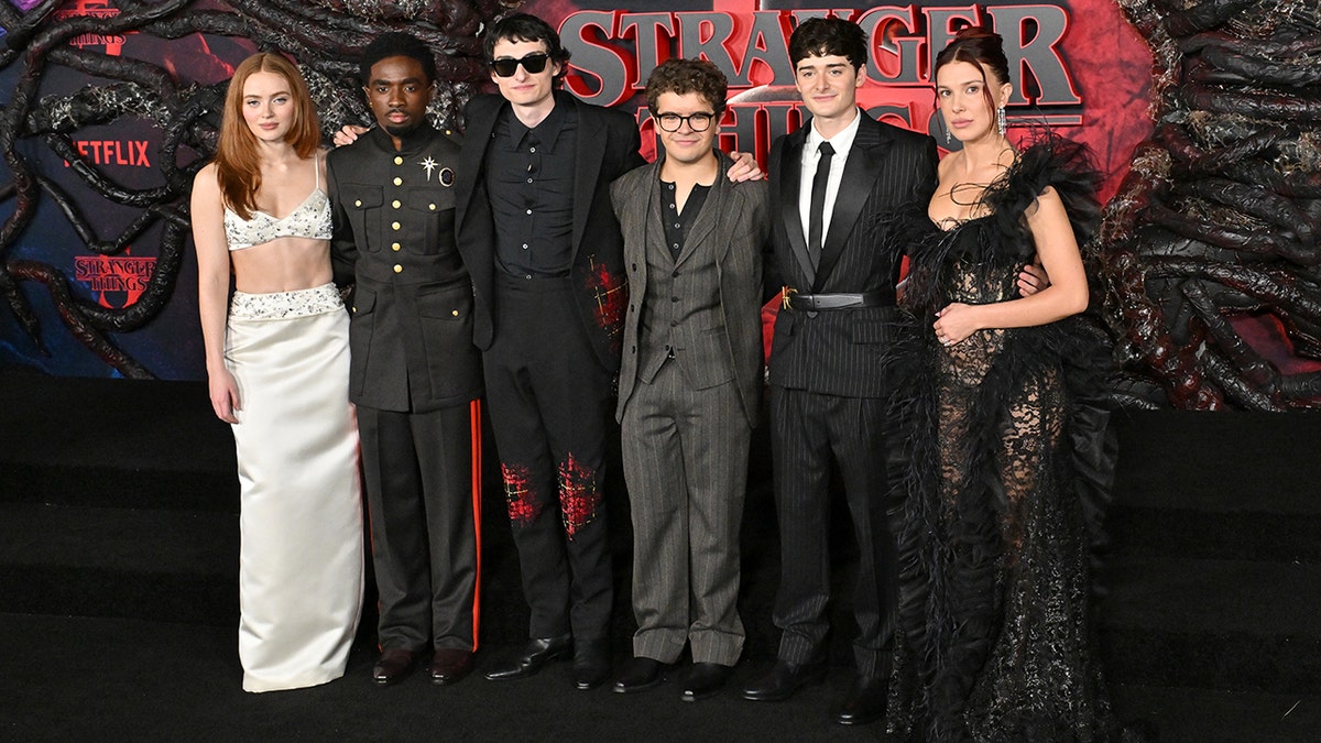Millie Bobby Brown poses with the cast of Stranger Things at premiere