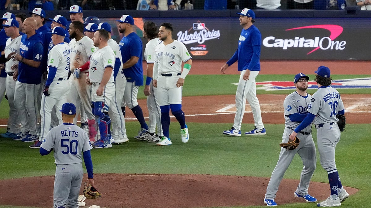 Players rush to the field to break up an incident