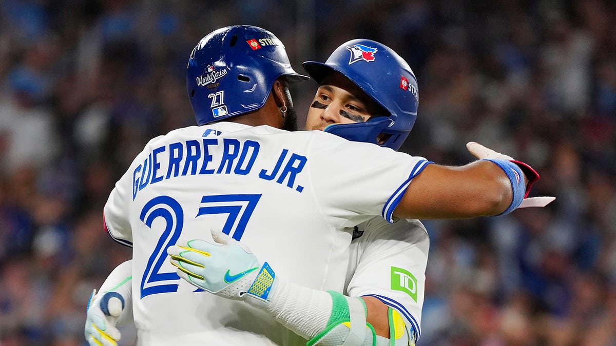 Bo Bichette hugs Vladimir Guerrero Jr.