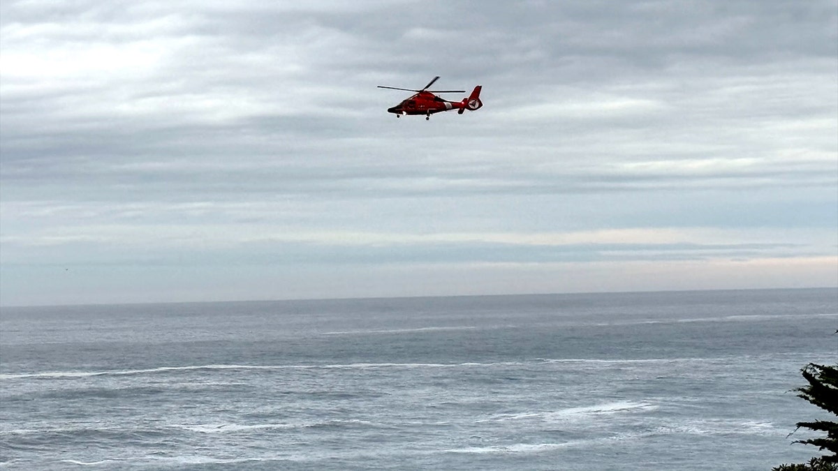 helicopter flying implicit the oversea adjacent the shoreline