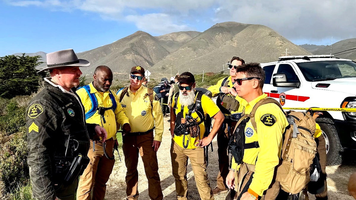Rescue squad members successful yellowish shirts lasting successful a ellipse and talking