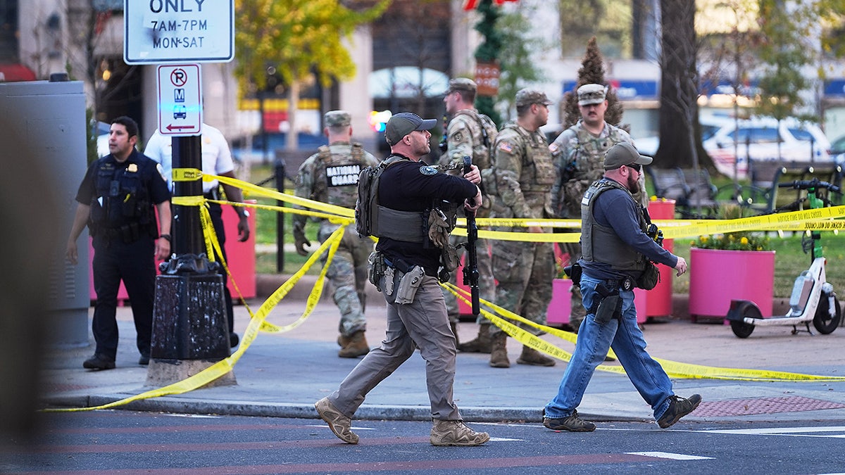 U.S. Marshals and National Guard troops are seen after two National Guard soldiers were shot near the White House in Washington, Wednesday, Nov. 26, 2025. (AP Photo/Evan Vucci)