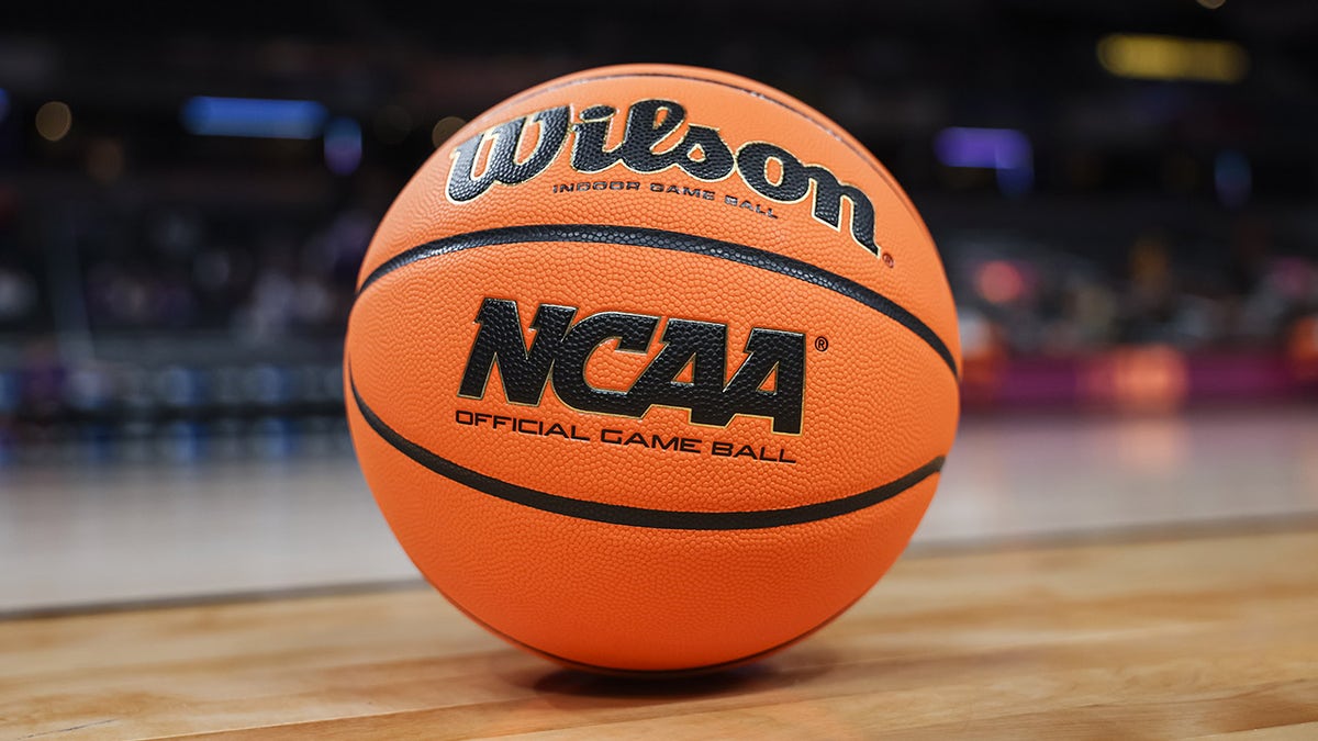 An NCAA basketball sits on a court