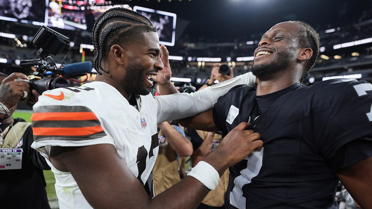 Shedeur Sanders laughs with Geno Smith