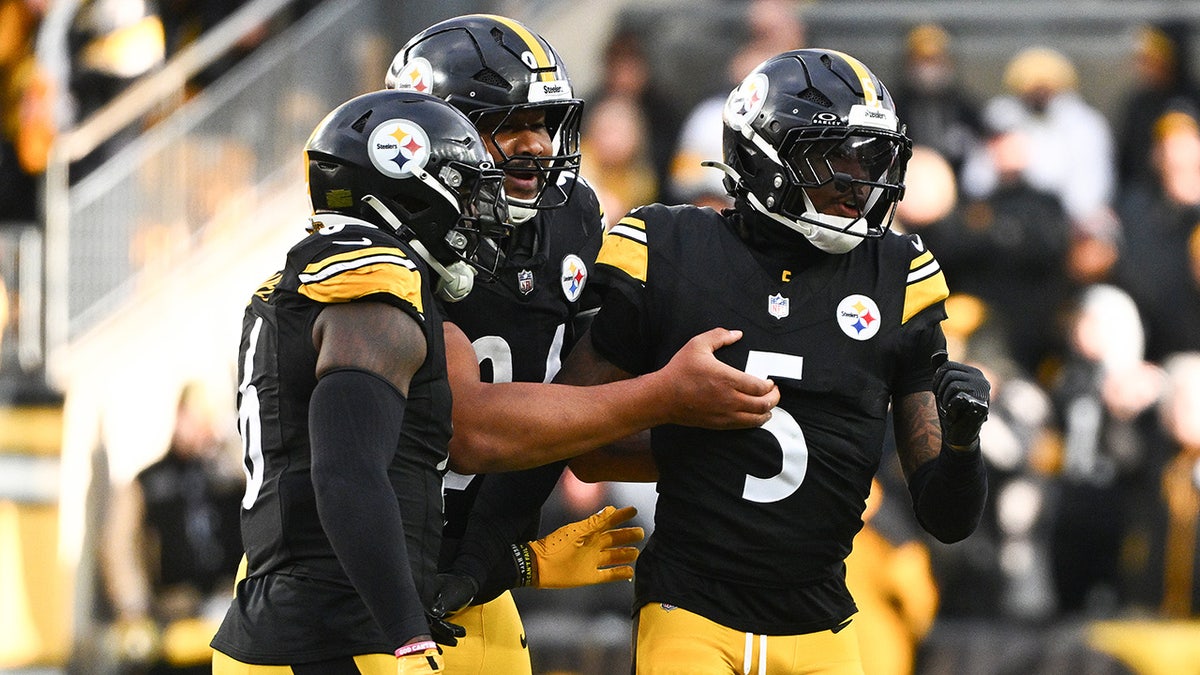 Jalen Ramsey is held back by teammates