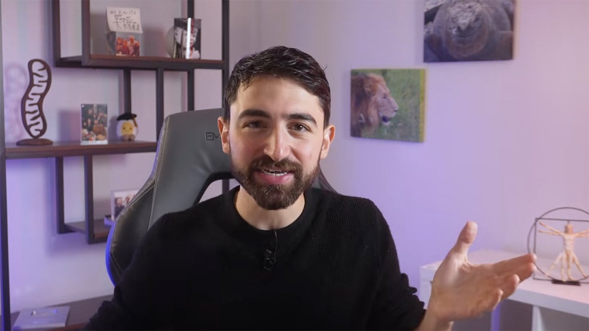Dr. Nick Norwitz seen in screenshot talking about his sardine diet, seen sitting at office chair with knick-knacks on shelves behind him.