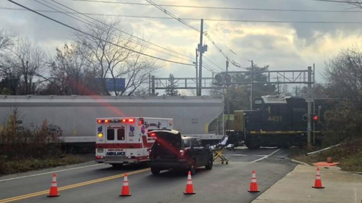 Crash scene with orange cones and ambulance