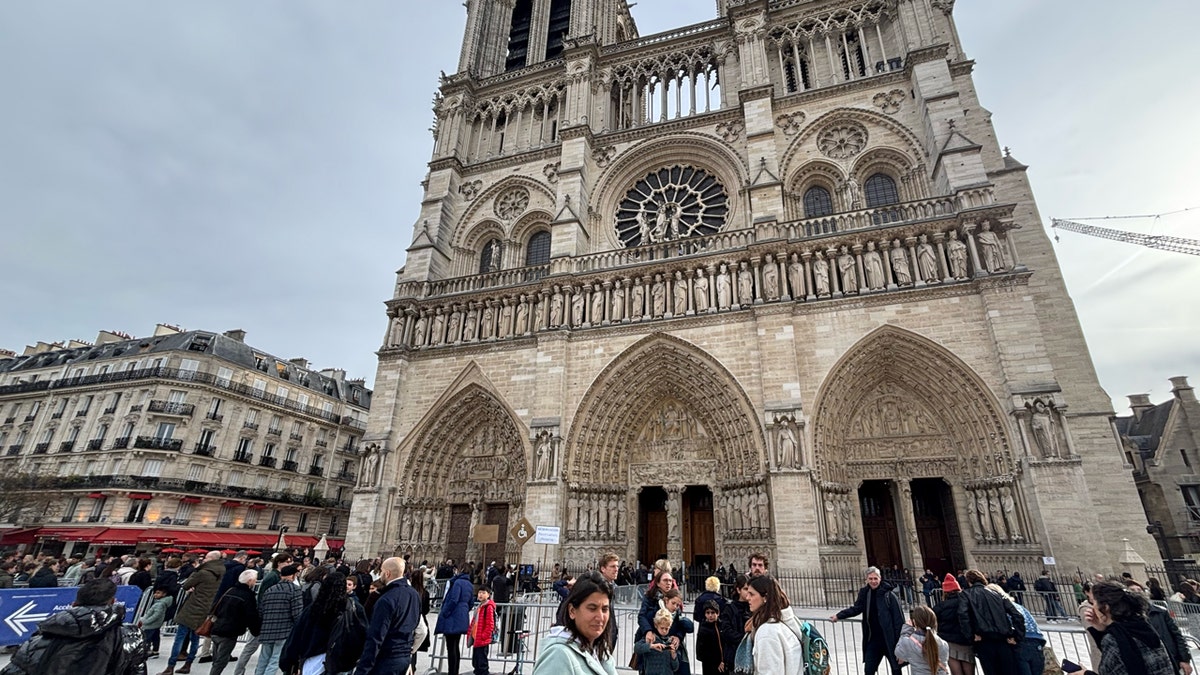 tourists in line outside of Notre Dame Cathedral