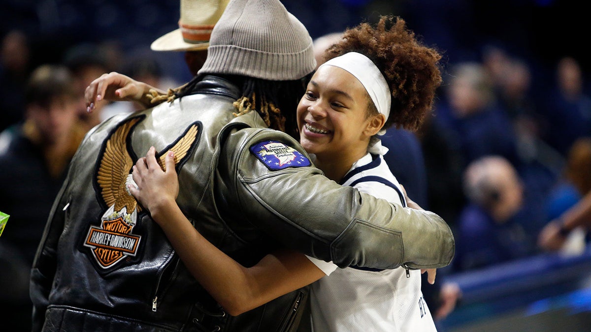 Hannah Hidalgo hugs a fan