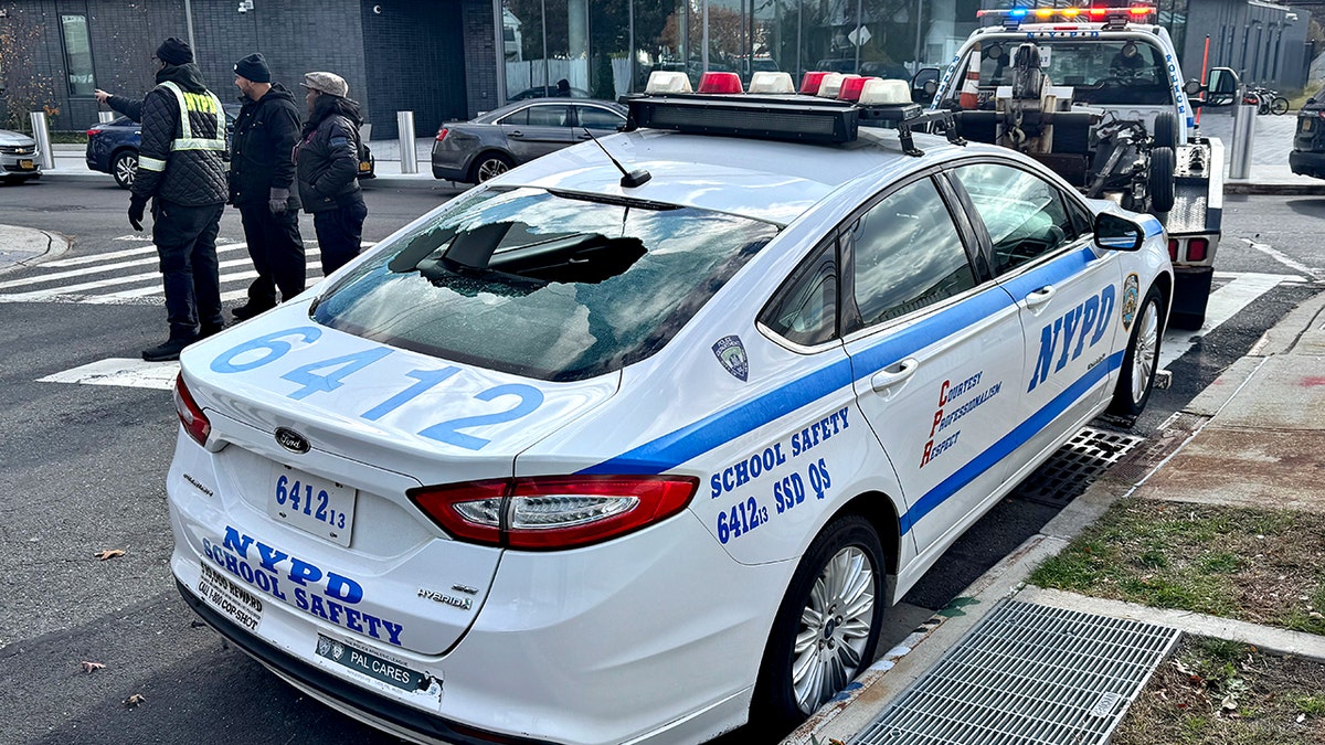 NYPD patrol car with breached backmost model being towed