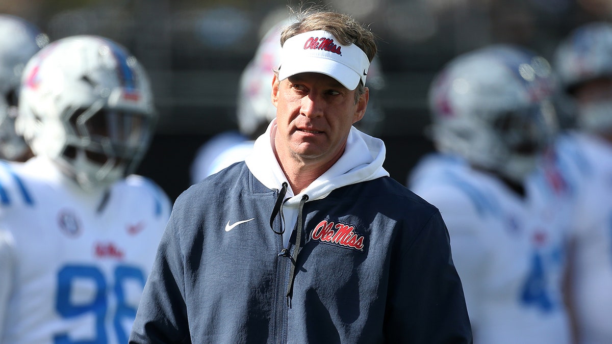 Lane Kiffin walks on the sidelines