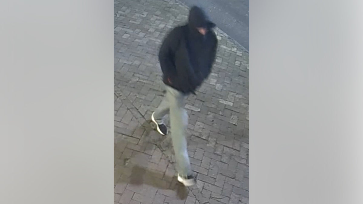 CCTV footage of Owen Kenney wearing a black hoodie walking