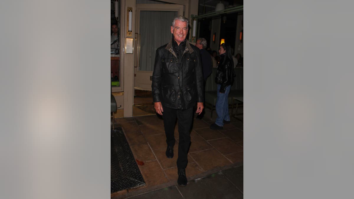 Pierce Brosnan smiles while leaving Dorian restaurant in London after a family dinner.