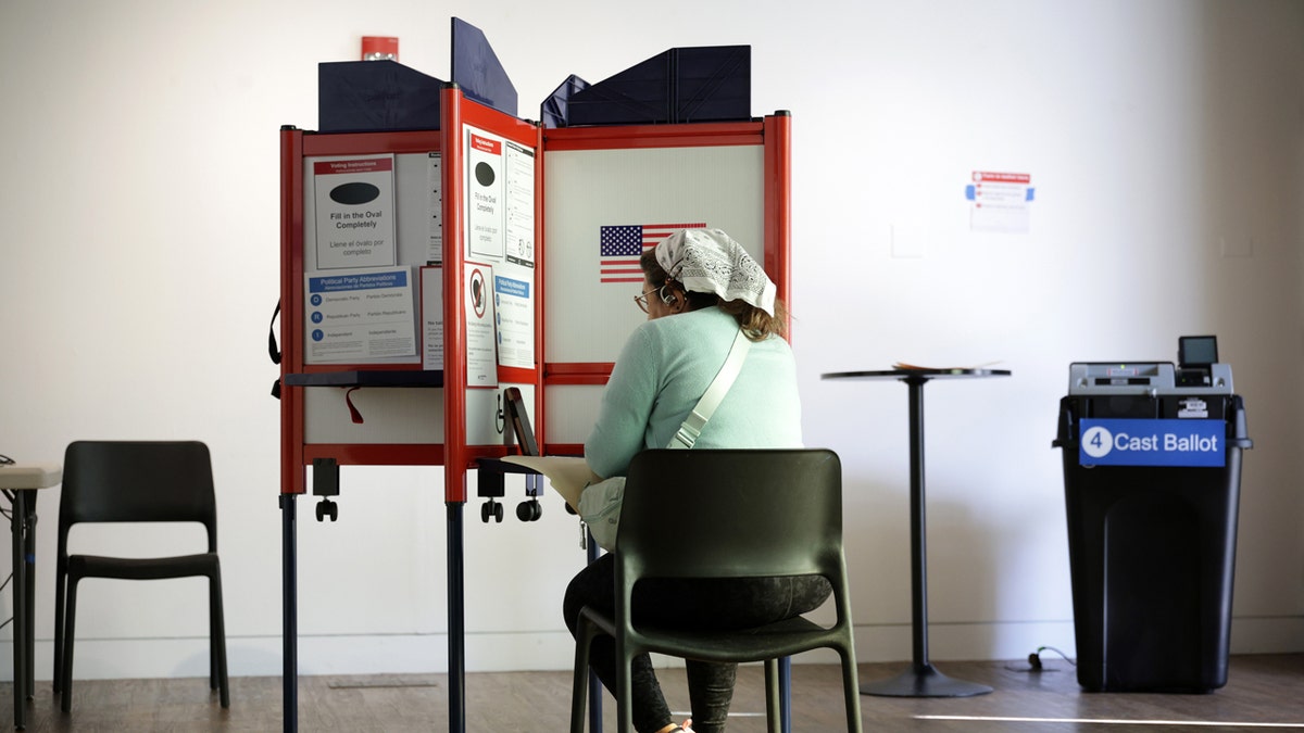 Woman sitting in a voting booth