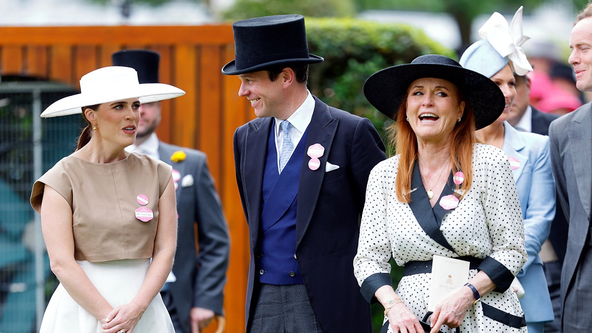 Princess Eugenie, Jack Brooksbank and Sarah Ferguson in formal wear talking and laughing at Ascot.