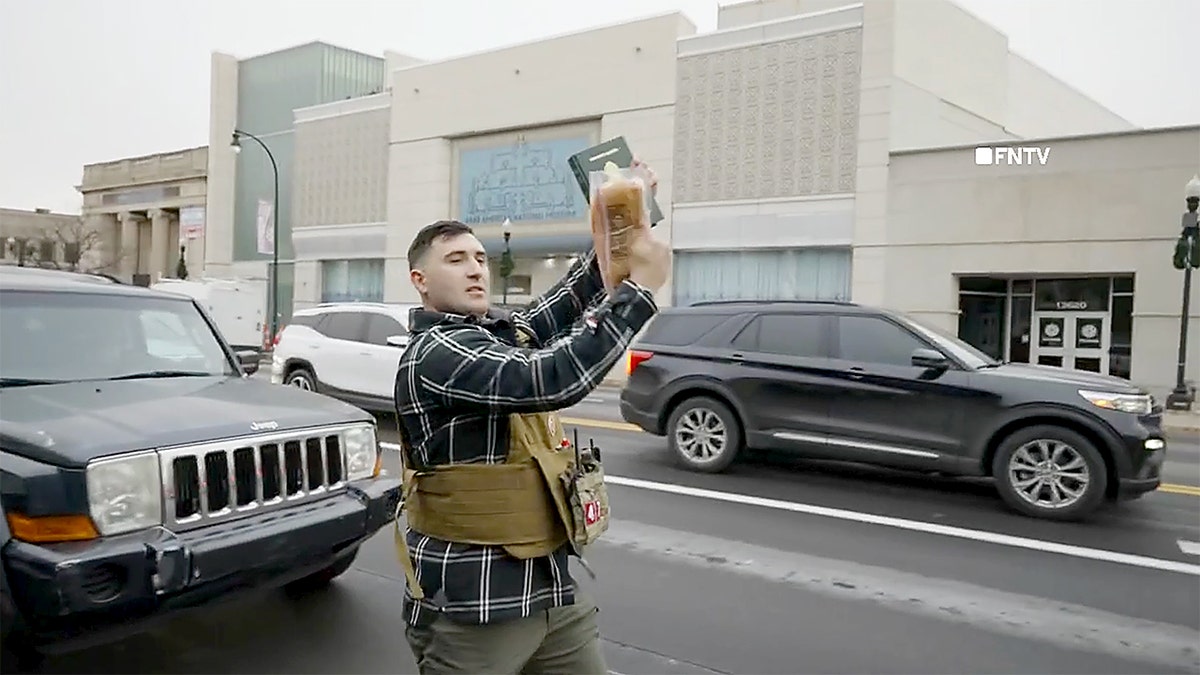 Jake Lang uses pork to hit a Quran in Dearborn, Michigan