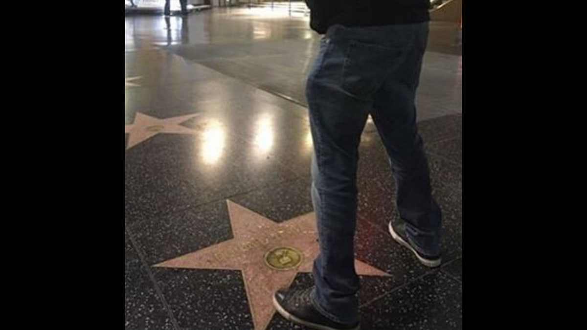 Bobby Pulido standing over Trump's Hollywood star
