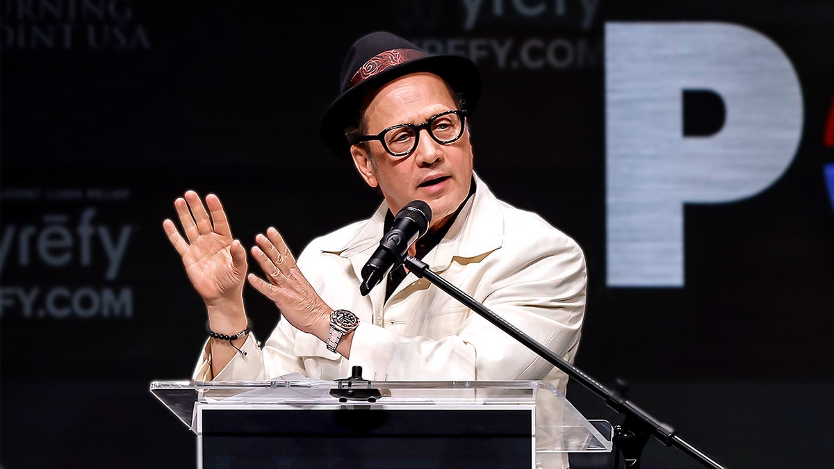 Comedian Rob Schneider speaks on stage during a Turning Point USA event at UC Berkeley.