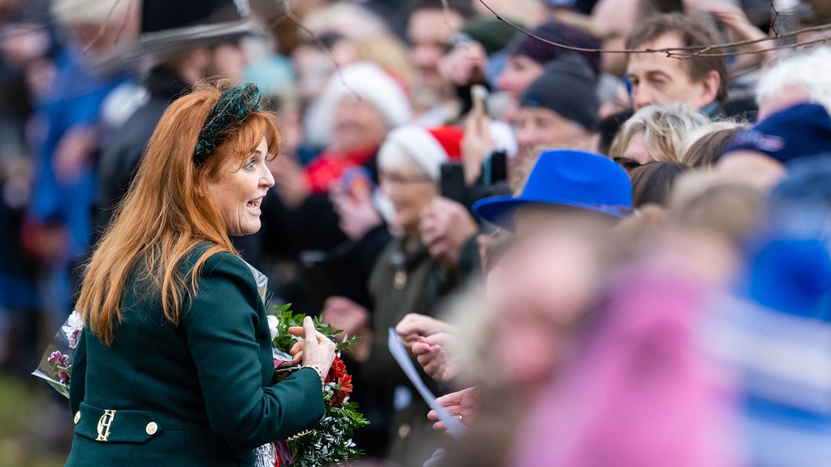 Sarah Ferguson in a green coat speaking with a crowd on Christmas day.
