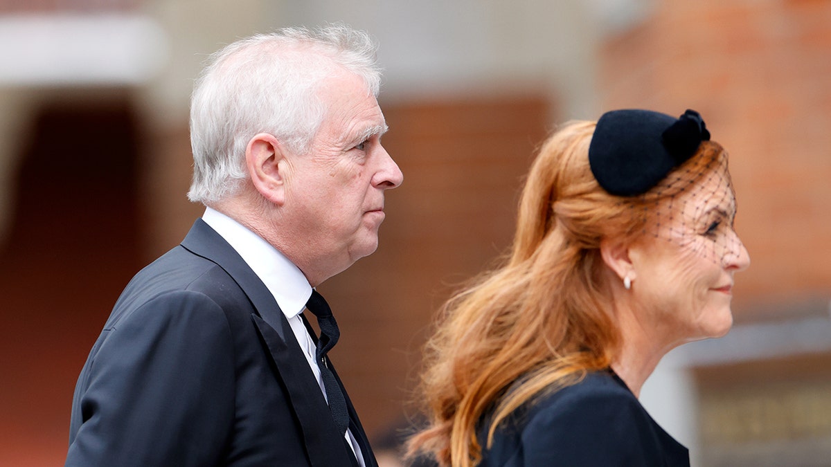 Sarah Ferguson and ex-Prince Andrew walking away wearing black.