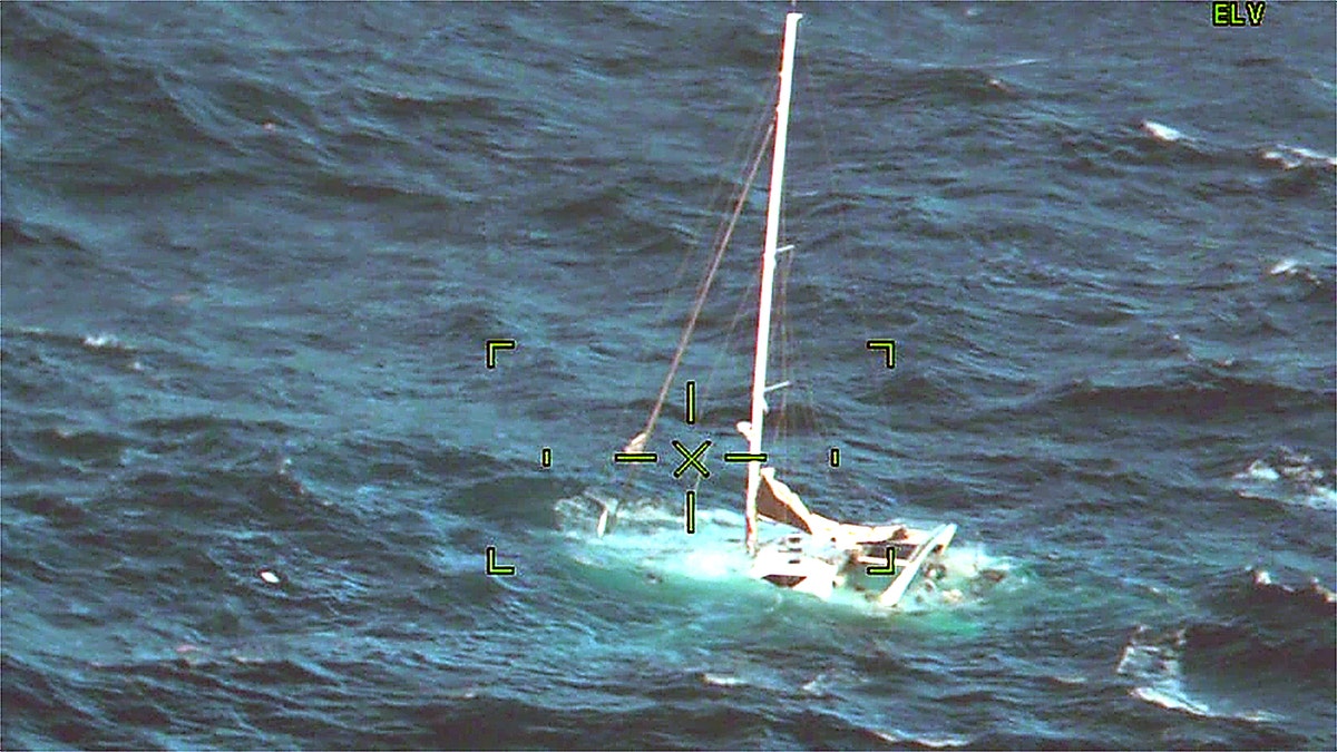 Sailboat sinking beneath waves