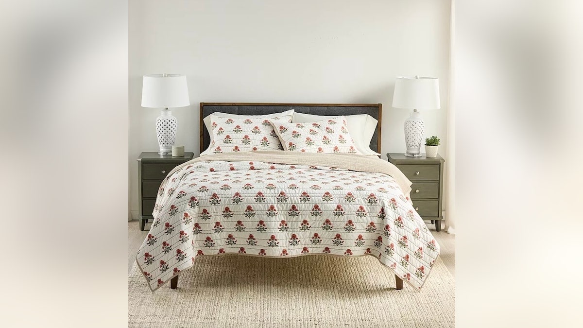 Cozy up your space with this embroidered quilt.