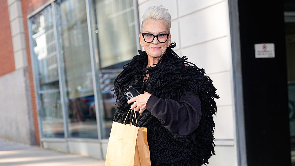 Susan Powter on the streets of NY in a black coat this November