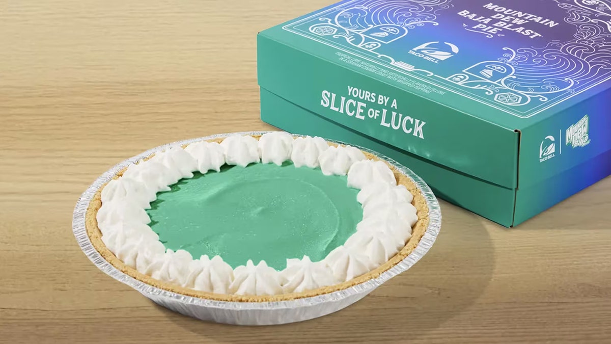 Taco Bell's new Baja Blast Mountain Dew pie, seen with whipped cream, next to turquoise box.