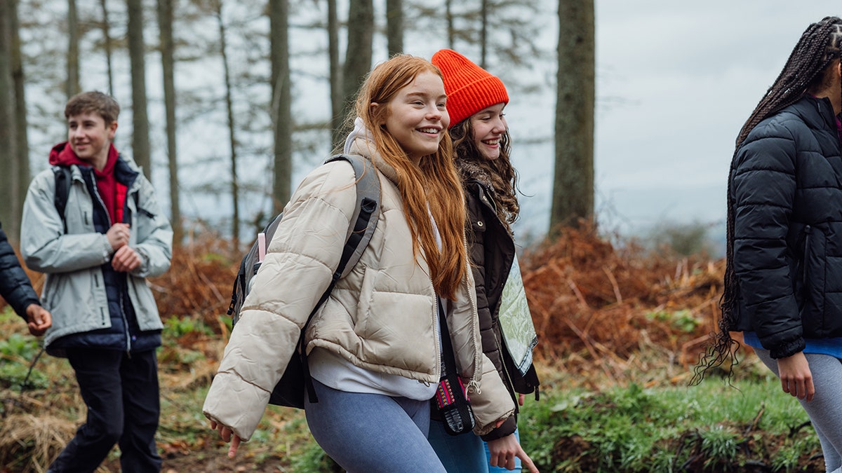teen girls walk together on a hike with friends