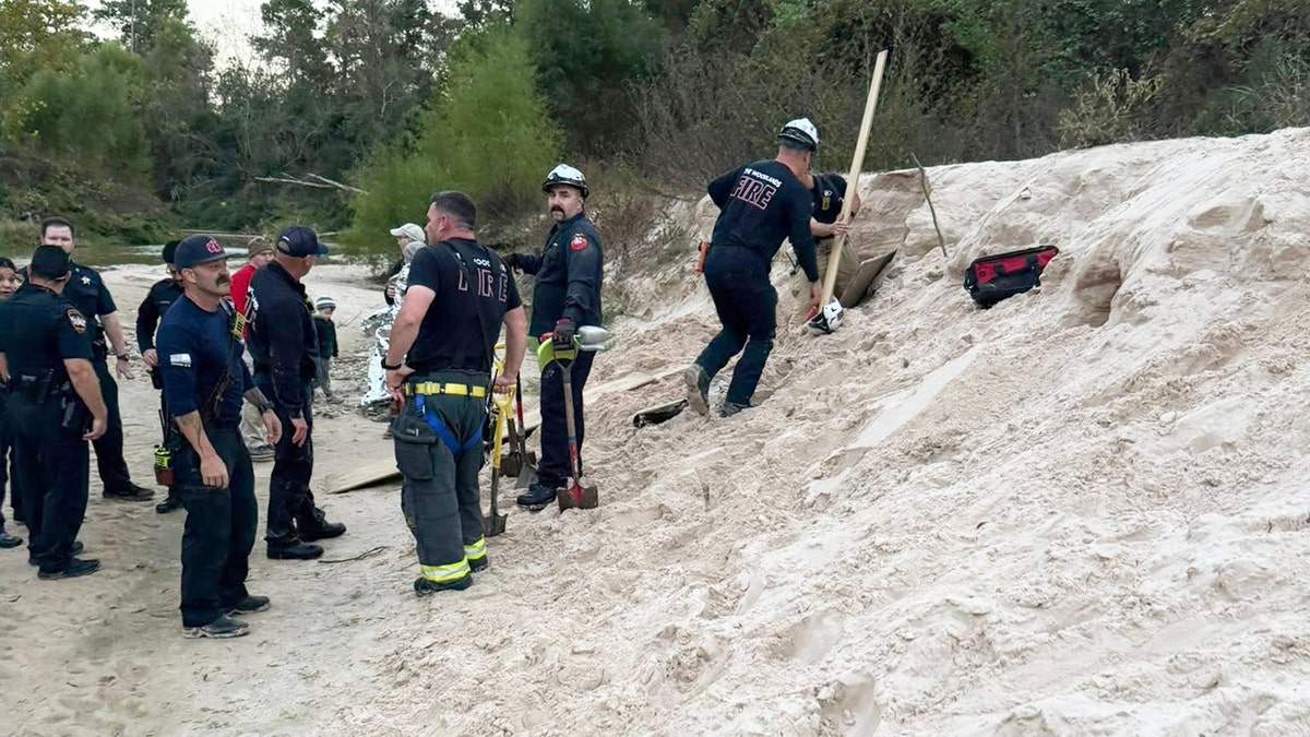 First responders hold shovels at site of sand rescue in Texas