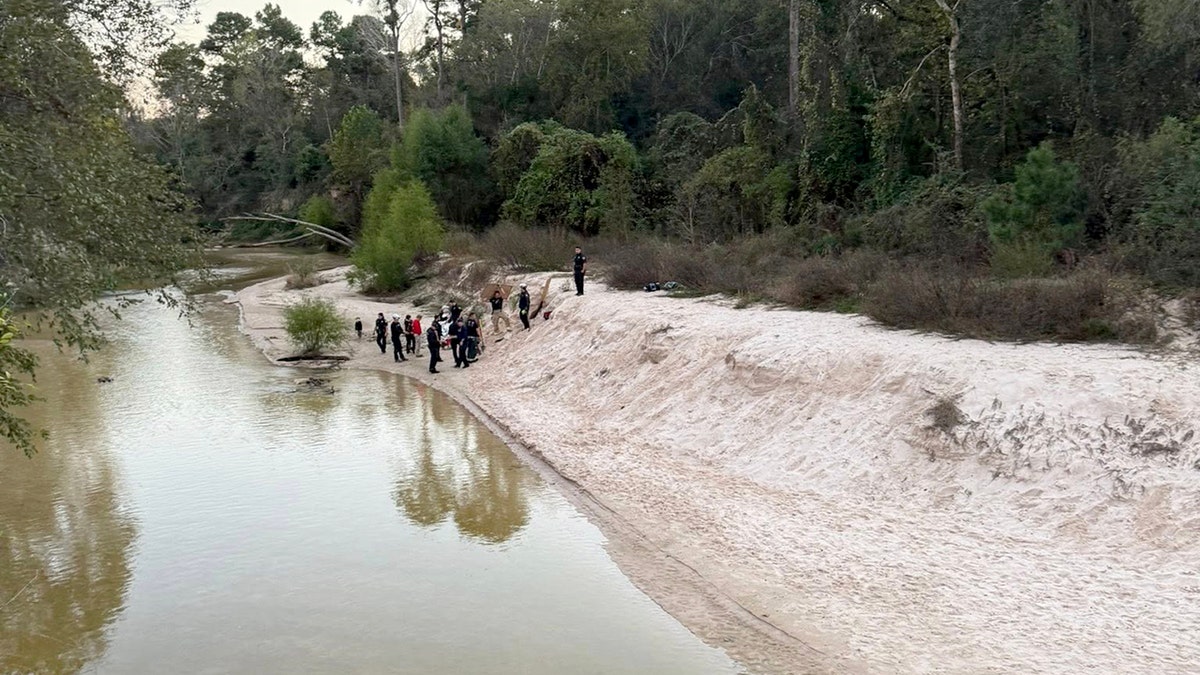 First responders standing along sand bar in Texas where girl became trapped
