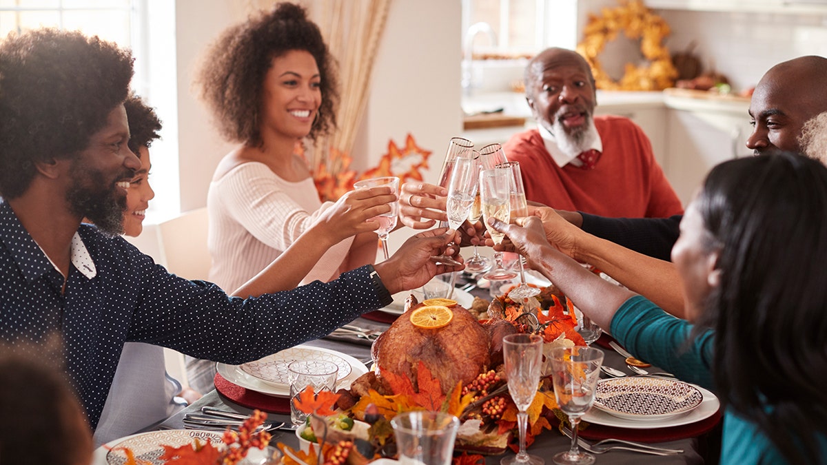 Family toasting over Thanksgiving meal