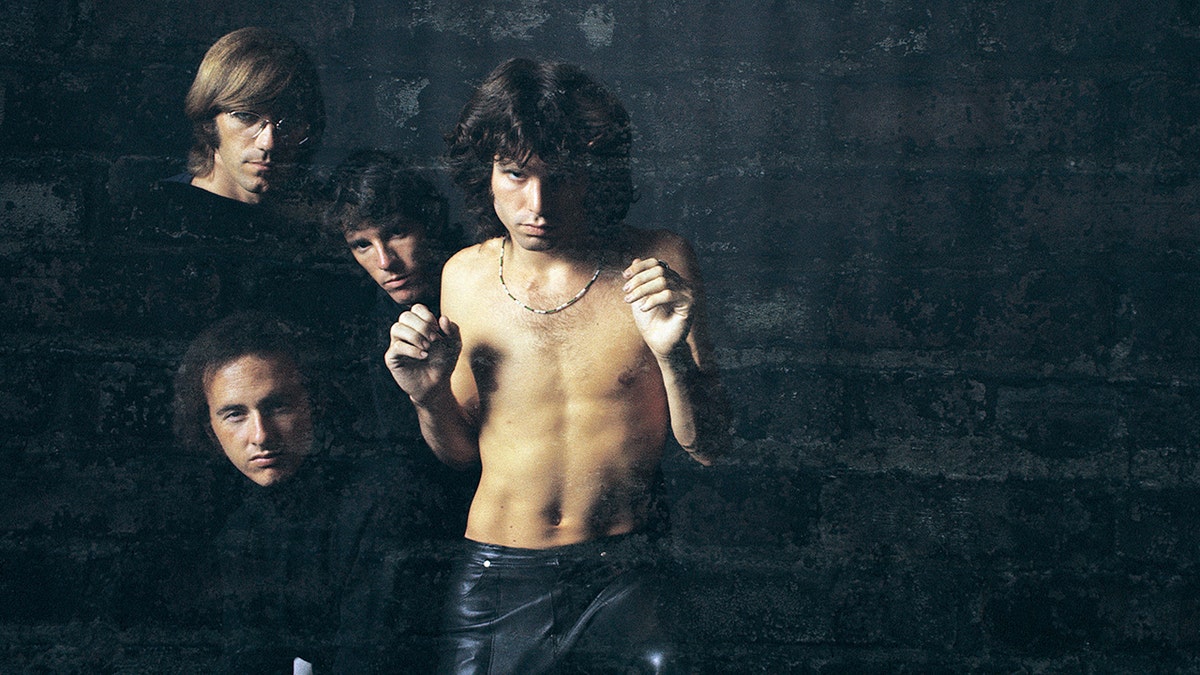 Jim Morrison shirtless with his band The Doors.