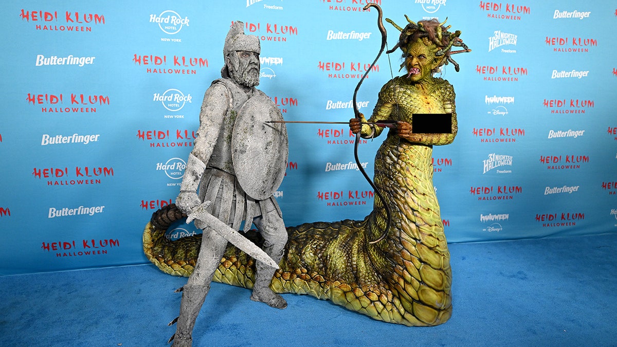 Heidi Klum and Tom Kaulitz dressed in elaborate Halloween costumes as an unlucky stone soldier and scaly Medusa during the annual event.