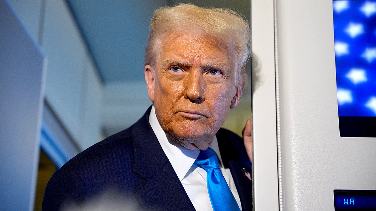 President Donald Trump speaks to reporters aboard Air Force One while traveling from Japan to South Korea.